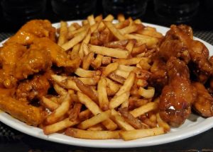 French Fries and Chicken wings on a plate